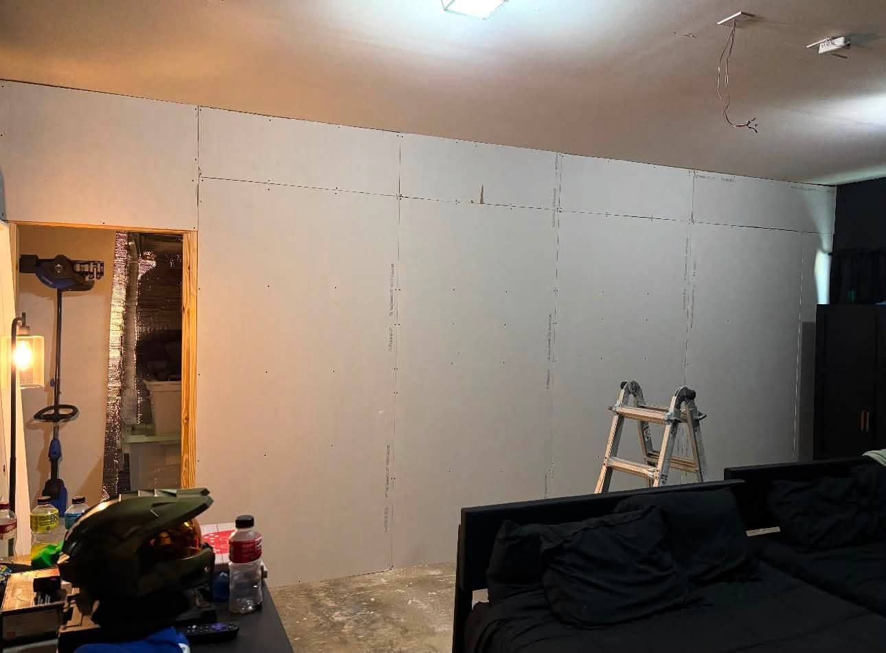 Drywall hung across the new wall