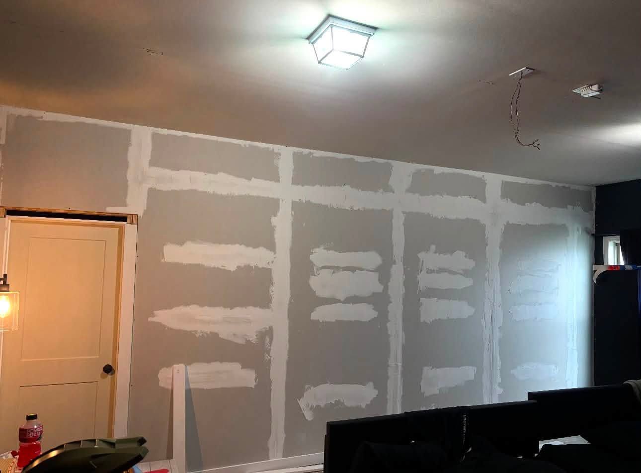 Drywall seams taped and mudded, ready for paint