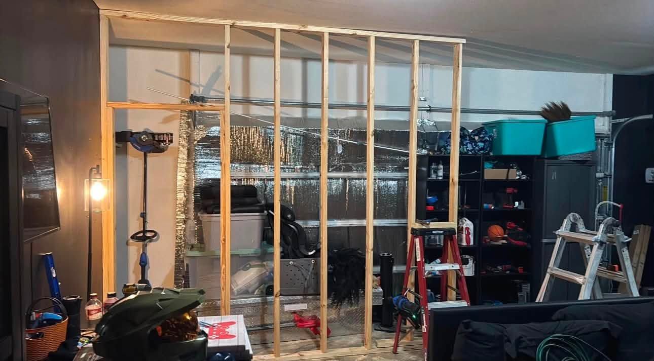 New stud wall framed across a garage