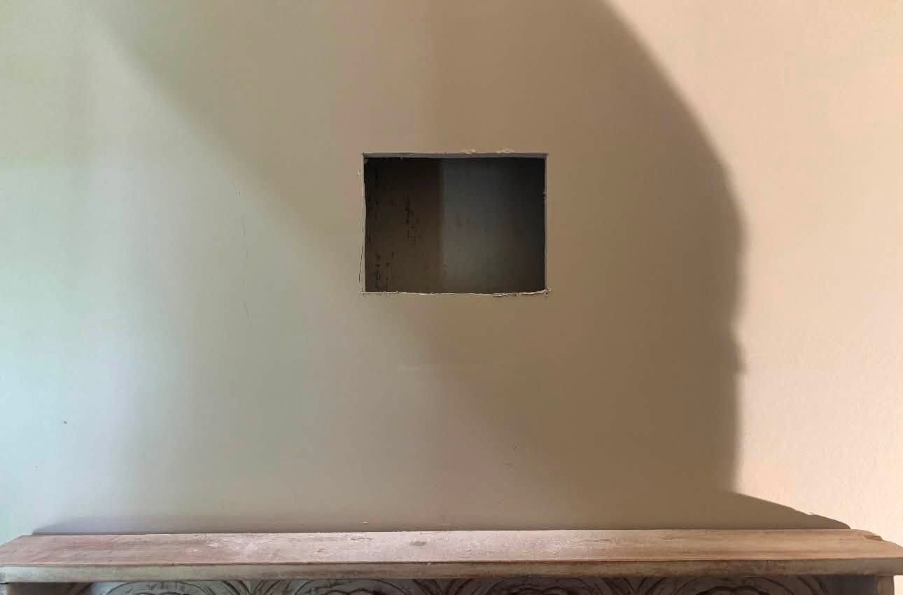 Opening cut in the drywall for the in-wall cable kit